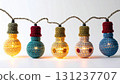 String of Decorative Crochet Light Bulbs with Warm Yellow Glow on White Background 131237707