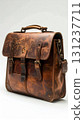 Distressed Brown Leather Satchel with Buckles and Brass Rivets in Studio Setting 131237711