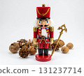 Red Nutcracker Figurine with Decorative Nuts on White Background 131237714