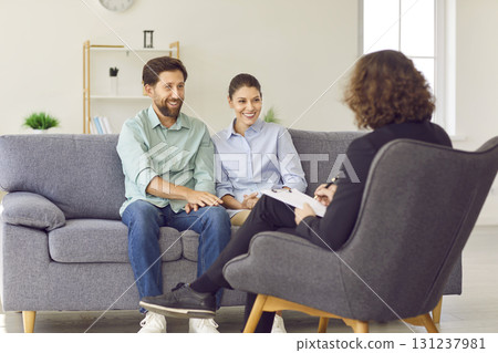 Happy, smiling husband and wife having session with professional psychotherapist Happy, smiling husband and wife having session with professional psychotherapist 131237981