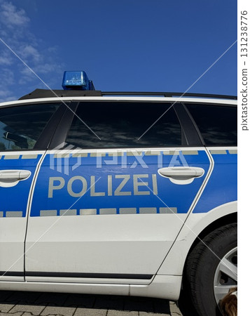 A police vehicle is situated under a clear blue sky, ready for action and patrolling the area A police vehicle is situated under a clear blue sky, ready for action and patrolling the area 131238776