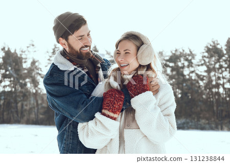 Two people spending a day in a winter forest and looking enjoyed and romantic Two people spending a day in a winter forest and looking enjoyed and romantic 131238844