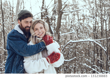 Young people feeling happy and in love while spending time together in a snowy forest Young people feeling happy and in love while spending time together in a snowy forest 131238883