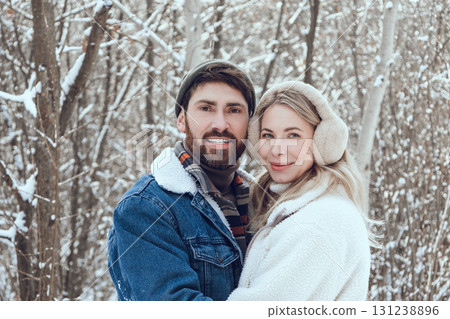 Young people feeling happy and in love while spending time together in a snowy forest Young people feeling happy and in love while spending time together in a snowy forest 131238896