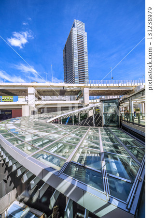 Yokohama cityscape in Japan. View of the north-west exit of Yokohama Station and tower apartment buildings. The large roof is impressive. 131238979