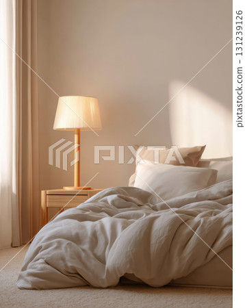 Cozy bedroom interior with comfortable bed, warm lamp, and nightstand. Natural sunlight creates peaceful, relaxing, and serene morning atmosphere in tranquil home 131239126