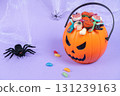 Various halloween sweets on pumpkin basket. Halloween 131239163