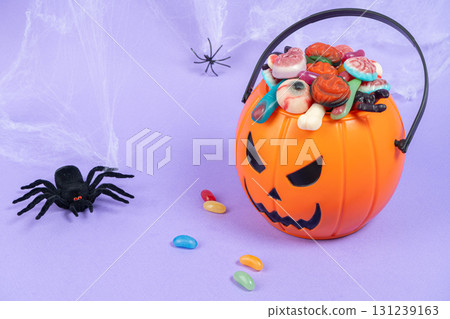 Various halloween sweets on pumpkin basket. Halloween 131239163