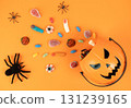 Halloween pumpkin basket with candies and spiders 131239165
