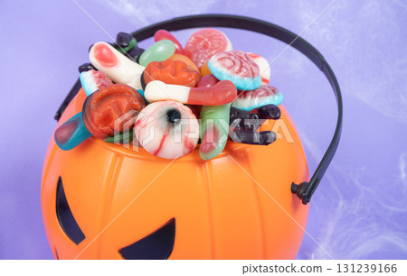 Halloween sweets on pumpkin basket. Halloween Halloween sweets on pumpkin basket. Halloween 131239166