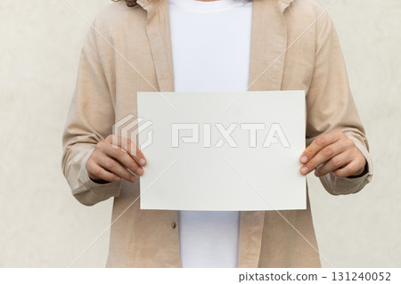 Hands Holding Blank Paper for Mockup Design Display 131240052