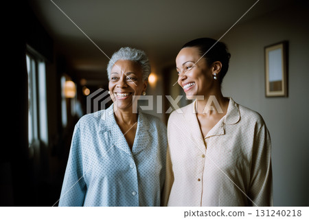 Two women smiling and holding hands 131240218