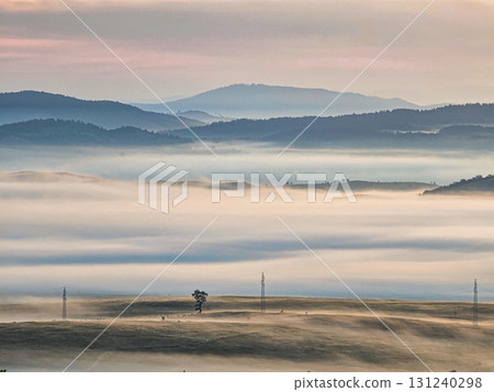 Misty autumn morning over the countryside and village in Zabljak, Montenegro. Fog drifts over fields and hills, creating a cozy and tranquil landscape. Ideal for travel, lifestyle, and seasonal Misty autumn morning over the countryside and village in Zabljak, Montenegro. Fog drifts over fields and hills, creating a cozy and tranquil landscape. Ideal for travel, lifestyle, and seasonal 131240298