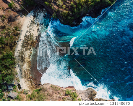 Rocky beach coastline with ocean waves crashing against cliffs. Rocky beach coastline with ocean waves crashing against cliffs. 131240670