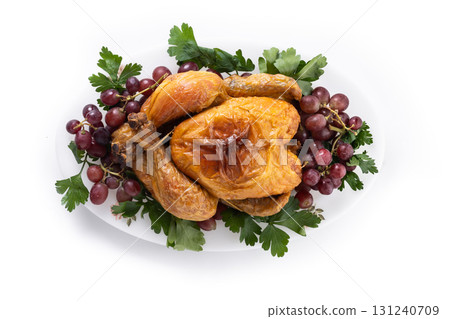 Roast turkey with grapes and parsley on white plate Roast turkey with grapes and parsley on white plate 131240709