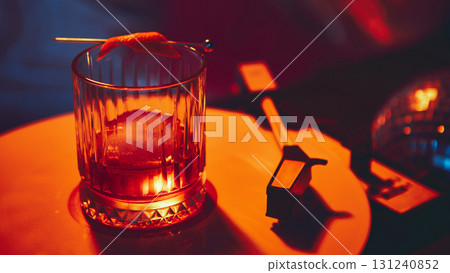 Elegant champagne coupe on vinyl record with purple background 131240852