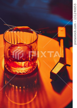 Martini cocktail with olives on golden vinyl under neon lights 131240853