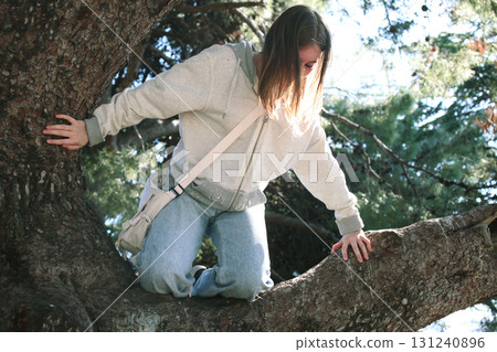 teenage girl outside in park lying on tree, lifestyle people teenage girl outside in park lying on tree, lifestyle people 131240896