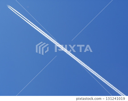 Long white jet is flying through the sky 131241019