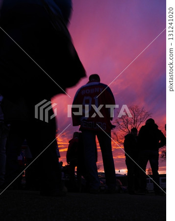 Man wearing a jersey with the number 91 on it stands in front of a group of pe 131241020
