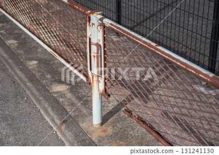 Damaged area of aging sidewalk fence Damaged area of aging sidewalk fence 131241130
