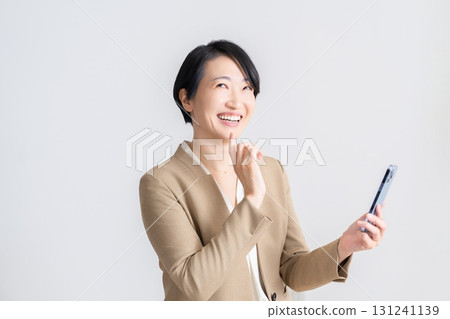 A woman watching a smartphone A woman watching a smartphone 131241139