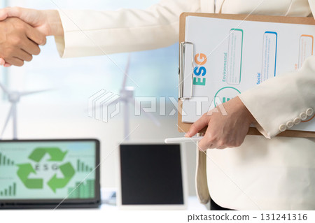 ESG handshake. Professionals sealing a deal with a focus on sustainability and governance. 131241316