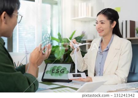 Engaging ESG conversation with light bulb and wind turbine models 131241342