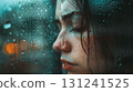 A beautiful woman stands by a rainy window, her face blurred and melancholic, reflecting themes of loneliness and sadness 131241525