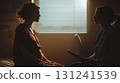 A pregnant woman is in silhouette, attentively listening to her doctor during a prenatal check-up in a dimly lit room 131241539