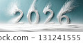 The year 2026 sculpted from snow with dynamic powder blasts on a minimalist blue background, symbolizing winter and new beginnings 131241555