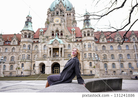 Elegant woman sitting near heritage building 131241886