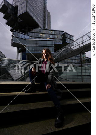 Fashion model sitting on city steps 131241906