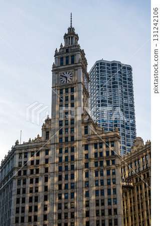 Iconic Chicago architecture featuring a historic clock tower and modern high-rise. 131242106