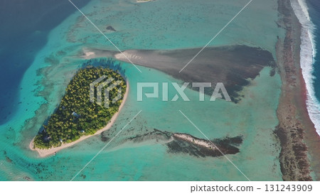 Aerial view of Tikehau tropical island in French Polynesia, turquoise water, lush vegetation palm trees, white beach, coral reef lagoon ocean barrier. Remote wild nature paradise, exotic summer travel Aerial view of Tikehau tropical island in French Polynesia, turquoise water, lush vegetation palm trees, white beach, coral reef lagoon ocean barrier. Remote wild nature paradise, exotic summer travel 131243909