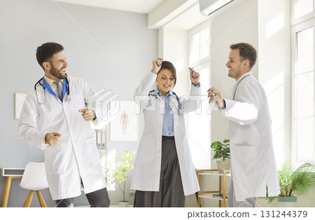 Doctors are enjoying lively celebration at their workplace, showcasing their joy and camaraderie. 131244379