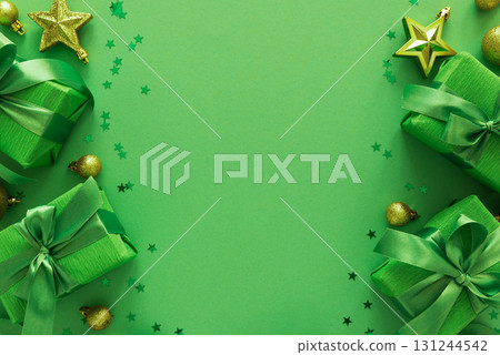 Green Gift Boxes with Gold Ornaments and Star Confetti on Festive Background 131244542