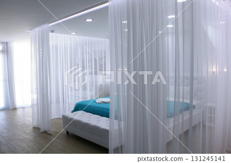 Four-poster bed. Cozy bedroom in bright colors. Scandinavian style design. Concept of recreation. 131245141