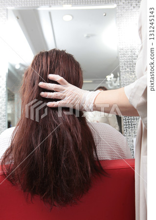 Dry hair. Hair care in beauty salon. Long hair before the procedure. Woman in beauty salon. Concept of hair care. Rear view. Dry hair. Hair care in beauty salon. Long hair before the procedure. Woman in beauty salon. Concept of hair care. Rear view. 131245143