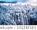 Aerial view of waterfall, house and snowy forest in winter 131245161