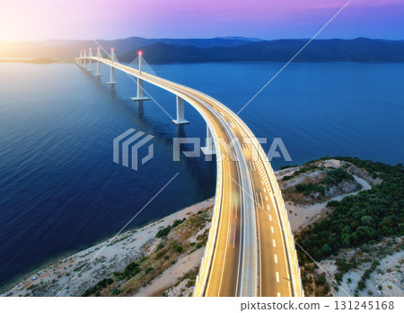 Aerial view of modern Peljesac bridge and blue sea at sunset Aerial view of modern Peljesac bridge and blue sea at sunset 131245168