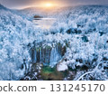 Aerial drone view of frozen waterfall, lakes in snowy forest 131245170