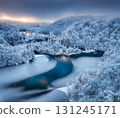 Aerial view of frozen lakes, waterfalls and snowy forest. Winter 131245171