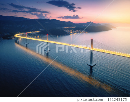 Aerial view of modern Peljesac bridge and blue sea at night Aerial view of modern Peljesac bridge and blue sea at night 131245175
