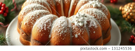 Bundt cake decorated for festive celebration with icing and holiday embellishments displayed on a white plate 131245536
