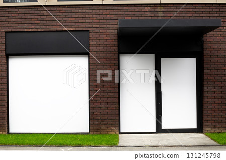 Modern commercial building facade featuring blank panels and minimalist design, ideal for showcasing logos and branding. Perfect mock up for retail businesses looking to customize their storefront 131245798