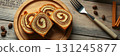Delicious swirl bread with cinnamon and chocolate served on a wooden platter in a cozy setting 131245877