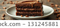 Delicious chocolate cake layered with creamy frosting served on a white plate in a cozy setting 131245881