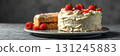 Deliciously crafted cake decorated with fresh strawberries served on a grey surface for a perfect dessert experience 131245883