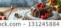 Delicious chocolate cake topped with cherries and surrounded by festive decorations during a winter celebration 131245884